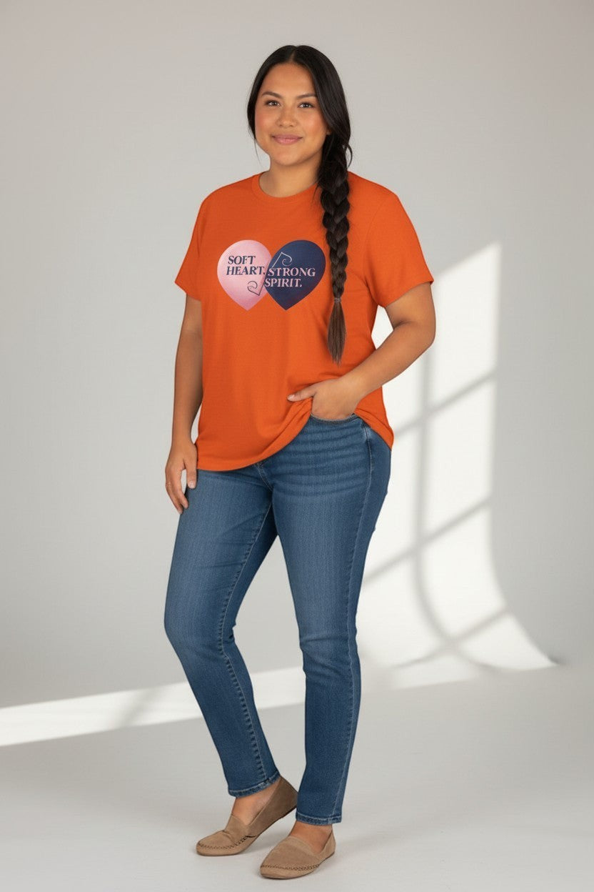 Woman wearing orange “Soft Heart Strong Spirit” t-shirt, a vibrant and expressive style.