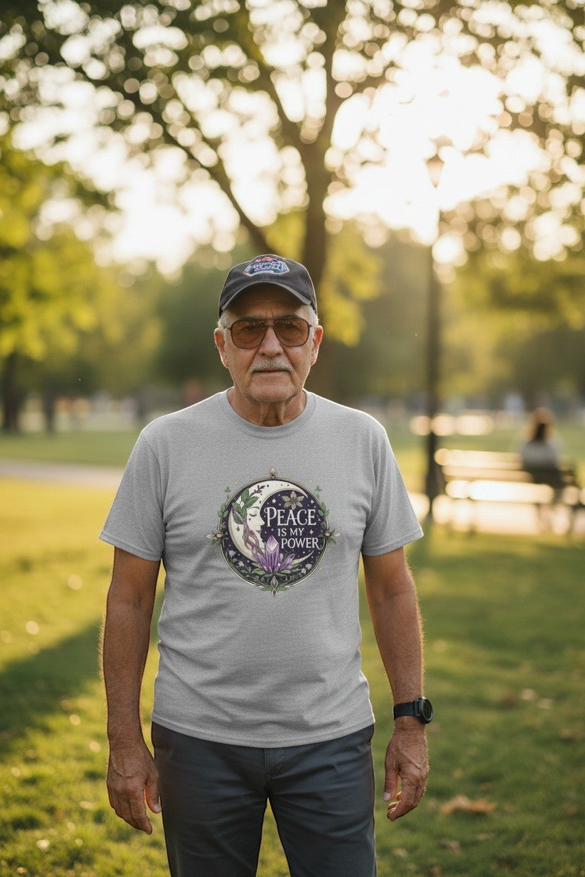 Man wearing grey peace affirmation t-shirt outdoors in a park, a calm and grounding everyday look.
