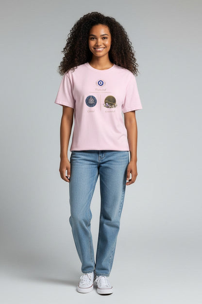 Woman wearing pink t-shirt featuring a symbolic graphic design, styled for a casual and uplifting look.