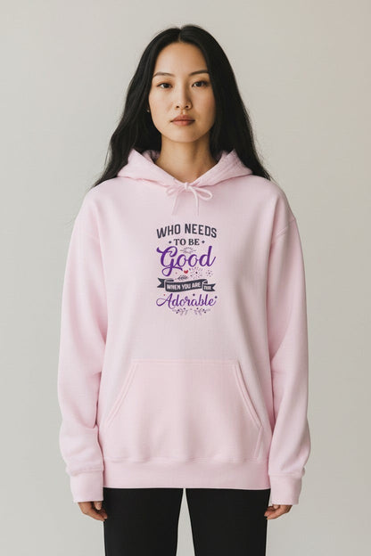 Woman wearing pink hoodie, a soft and cozy graphic sweatshirt perfect for relaxed outfits.
