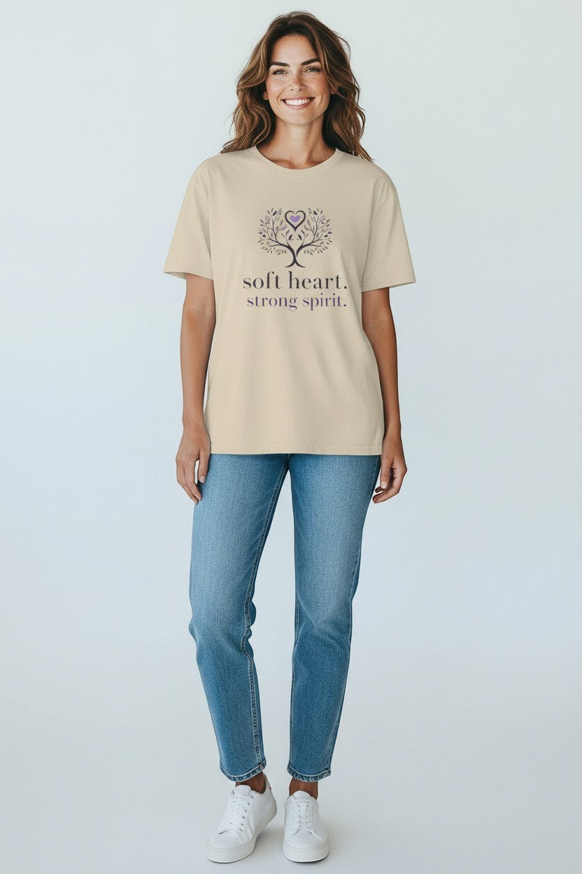 Woman wearing sand-colored “Soft Heart Strong Spirit” t-shirt, a comfortable and uplifting daily look.