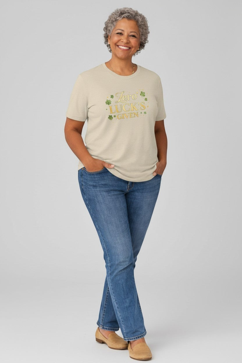Woman wearing sand-colored “Zero Luck’s Given” shirt, a comfortable and stylish everyday tee.