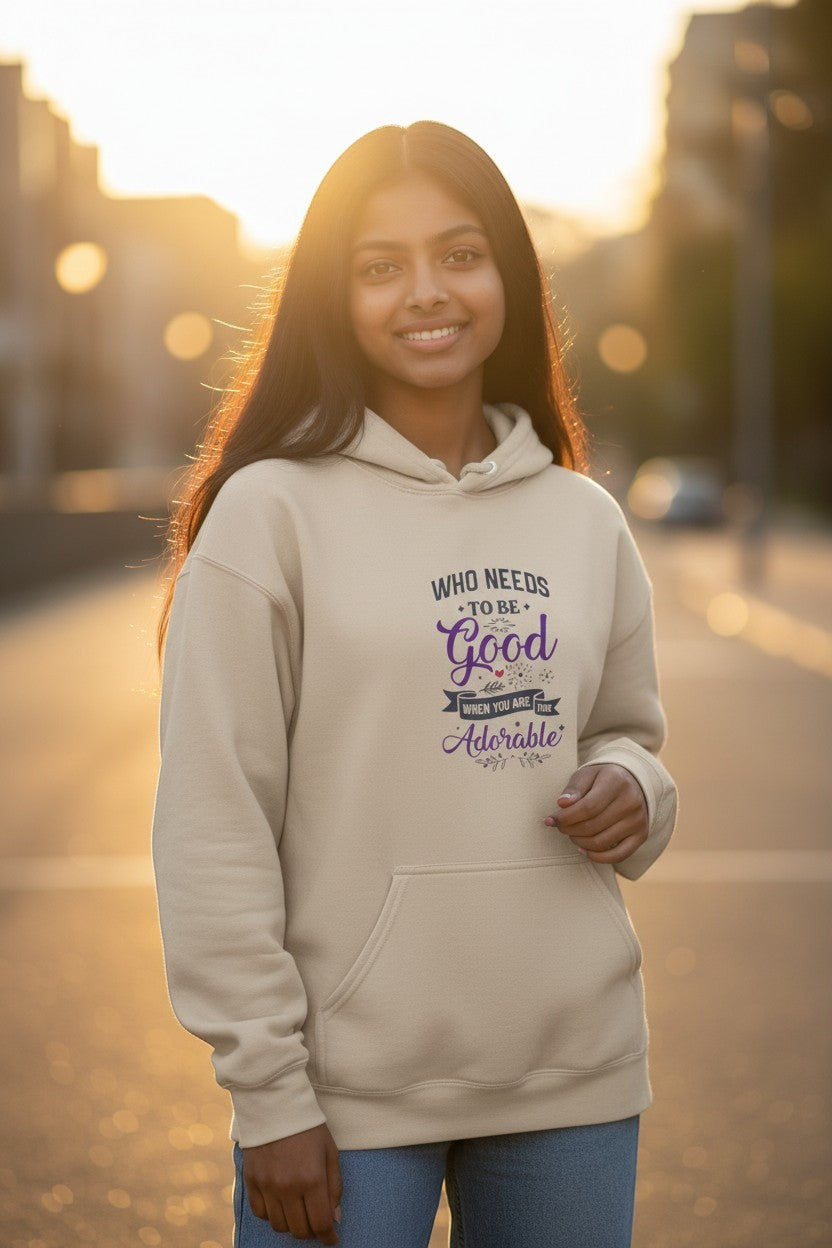 Woman wearing beige graphic hoodie in a cozy golden hour setting, perfect for fall outfits and casual streetwear.