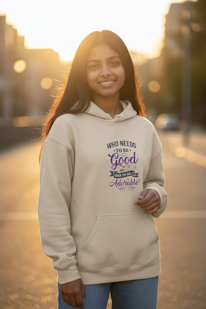 Woman wearing beige graphic hoodie in a cozy golden hour setting, perfect for fall outfits and casual streetwear.