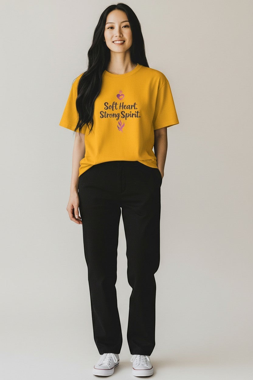 Woman wearing yellow “Soft Heart Strong Spirit” t-shirt, a bright and inspiring everyday outfit.