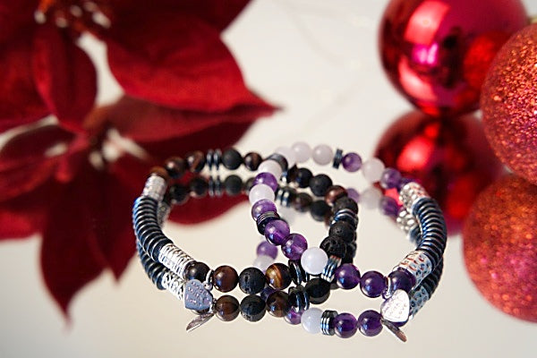 Say it with code 7" stretch bracelet made with amethyst, hematite, and Angola quartz beads with base metal spacers and  8" stretch bracelet made with lava stone, hematite, and tiger's eye with base metal spacers both read Focus in morse code