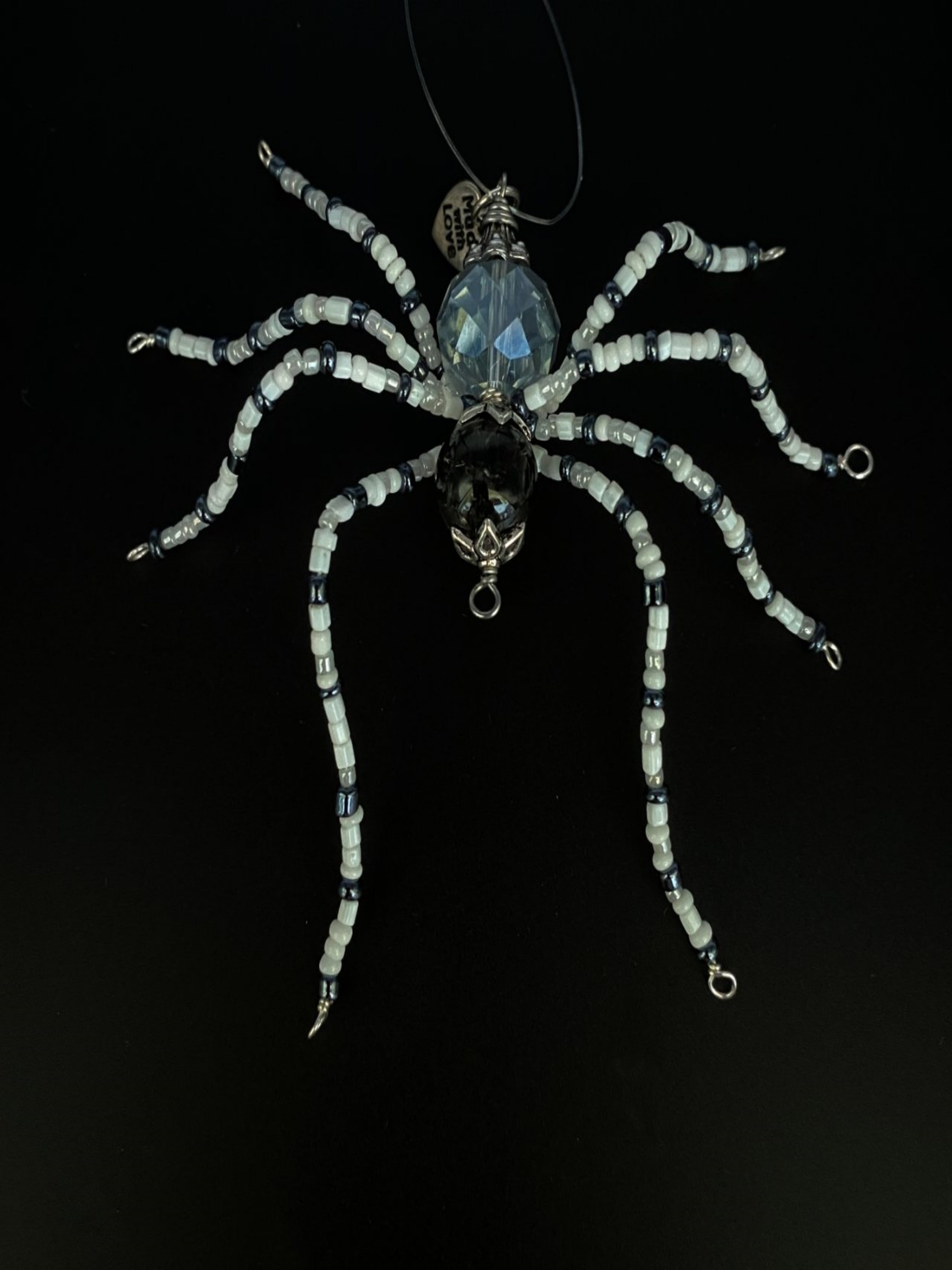 Black and White Christmas spider with black bead head and clear bead body. With and black glass seed beads on the legs.