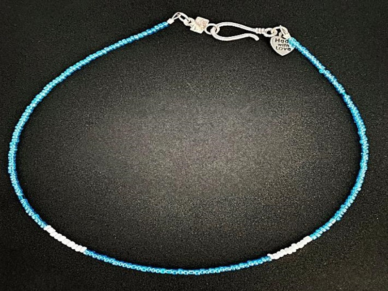 Blue and White Glass Seed Bead Necklace small blue and white glass seed beads with a base metal clasp and made with love charm