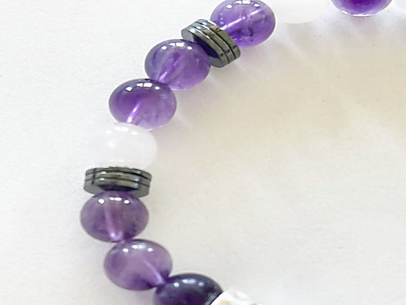 Say it with code 7" stretch bracelet made with amethyst, hematite, and Angola quartz beads with base metal spacers reads Focus in morse code