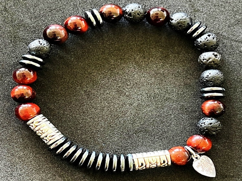 8" stretch bracelet made with lava stone, hematite, and tiger's eye with base metal spacers reads Focus in morse code