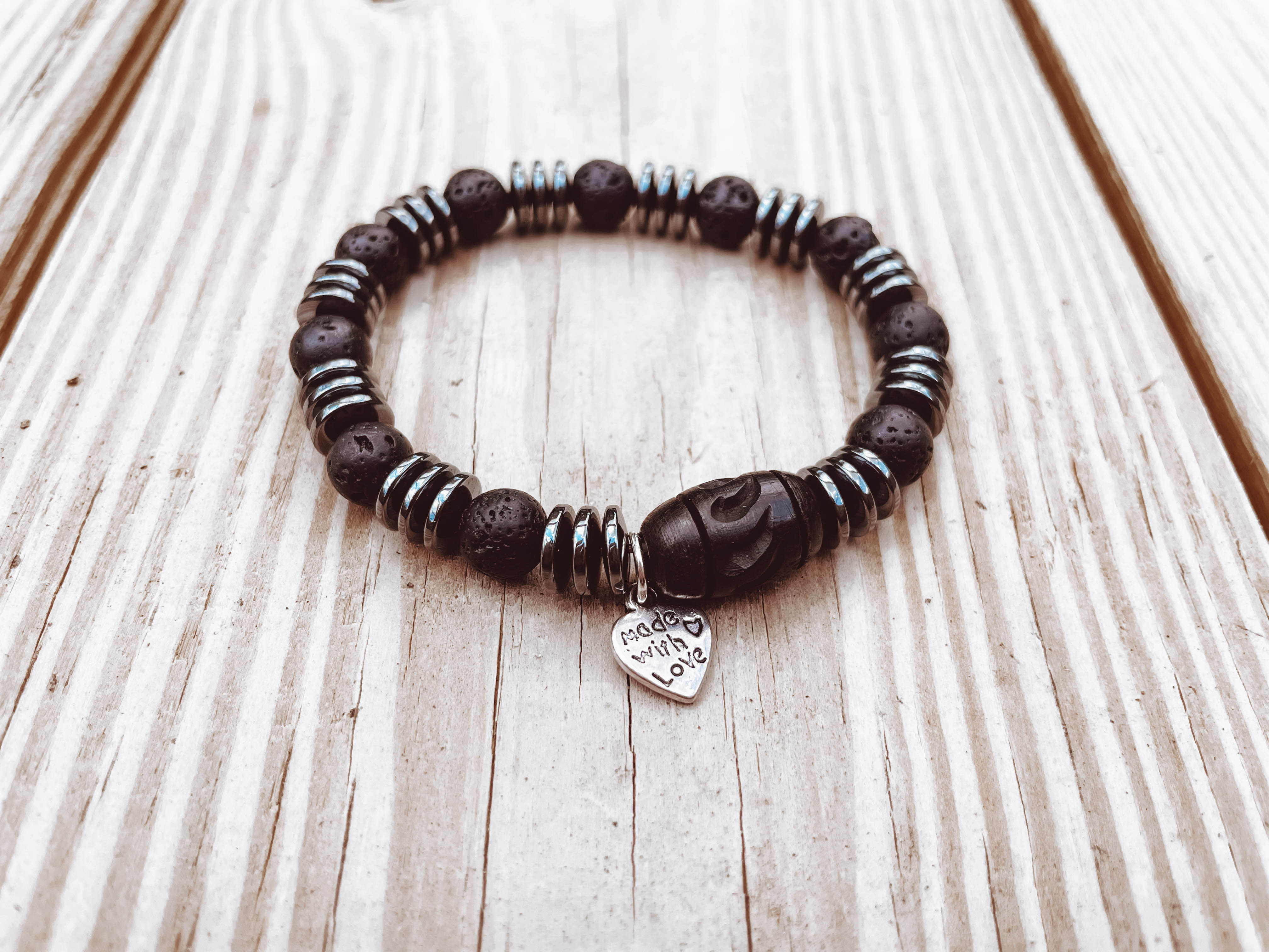 Black Hematite and Lava Stone Stretch Bracelet Stretch bracelet with black hematite disks, lava stones, and wooden carved Celtic beads.