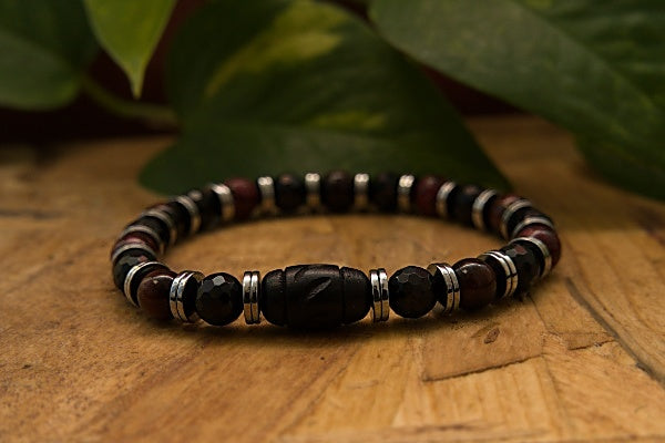 Stretch Bracelet made with Hematite, Mookaite Jade, and Tourmaline with base metal spacers.The stones of each piece are different colors and textures, giving this bracelet a unique look. Each stone has a specific frequency that helps ground you and balance your energy.