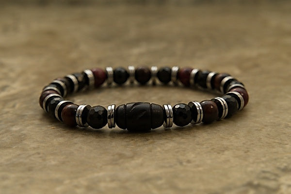 Stretch Bracelet made with Hematite, Mookaite Jade, and Tourmaline with base metal spacers.The stones of each piece are different colors and textures, giving this bracelet a unique look. Each stone has a specific frequency that helps ground you and balance your energy.