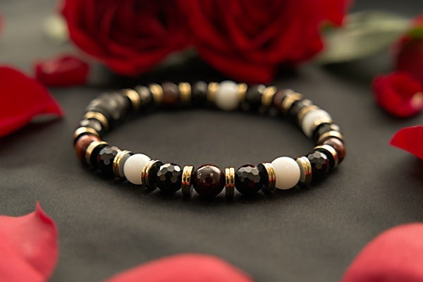 Black Tourmaline, Snow Jade, African Red Sandalwood Mala Stretch Bracelet with black tourmaline round beads, round snow jade beads, and round african red sandalwood mala bead with disk shaped metal spacer and focal carved black wooden bead