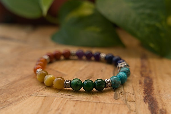 Chakra Stretch Bracelet made with Red Ruby beads. Contains all the colors of the Chakra Red, Orange Yellow, Green, Blue, Indigo, & Violet